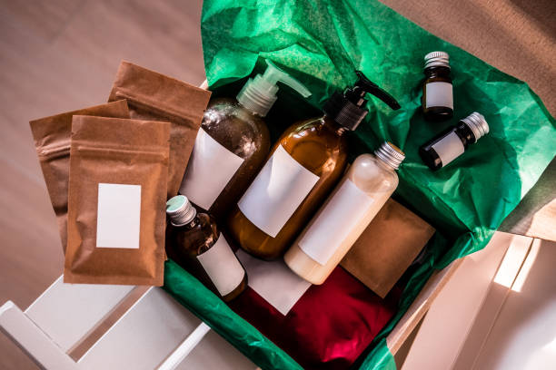 Beauty box with bottles of natural cosmetics, wrapped in green paper. Blogger hair and body care routine, salon treatments. Minimalism