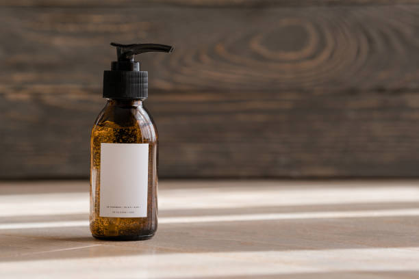 One cosmetic dark amber glass bottle on wooden background. Closeup, copyspace. Beauty blog, salon treatment concept, minimalism brand packaging mock up